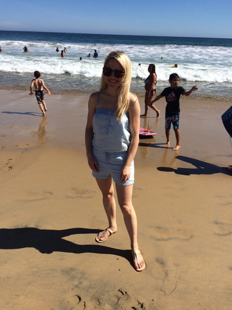 girl in jean romper on the beach, beach outfit ideas