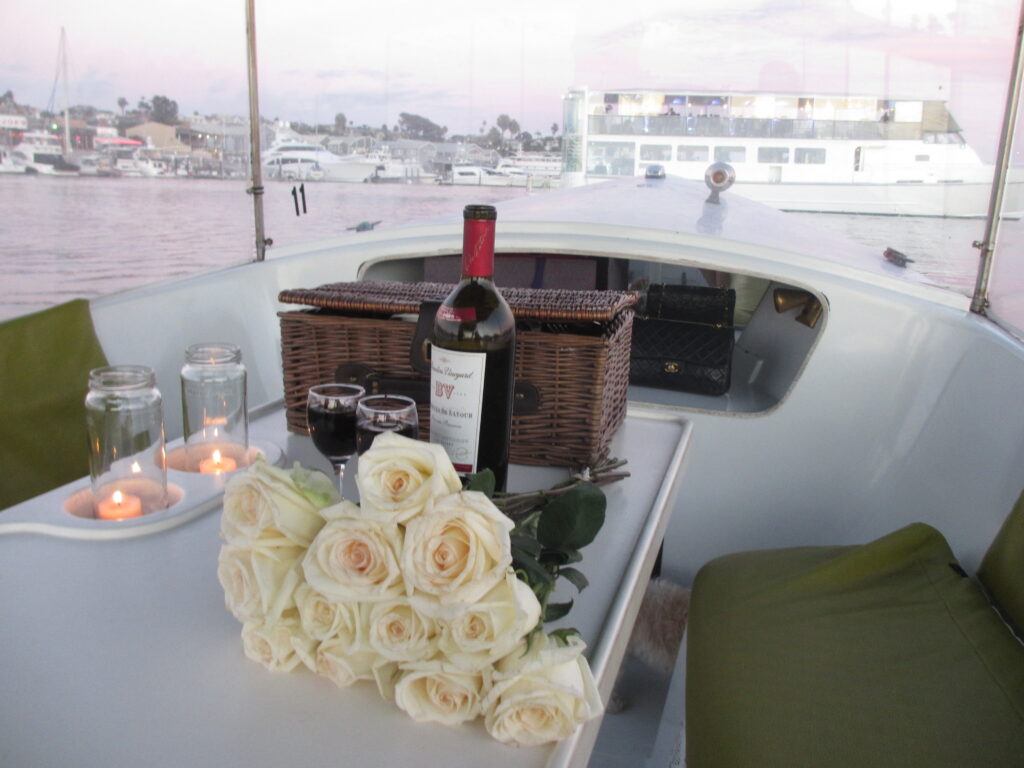 sunset duffy boat ride with flowers, wine and a picnic basket