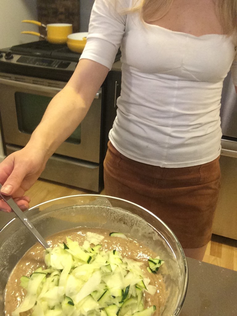 Caitlin Hartley of Styled American shreaded zucchini in bread mixture