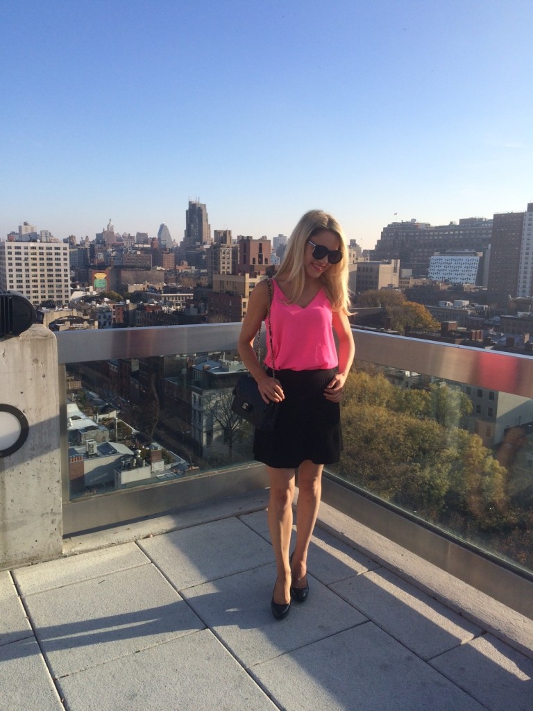 Caitlin Hartley of Styled American bright pink tank top and black mini skirt