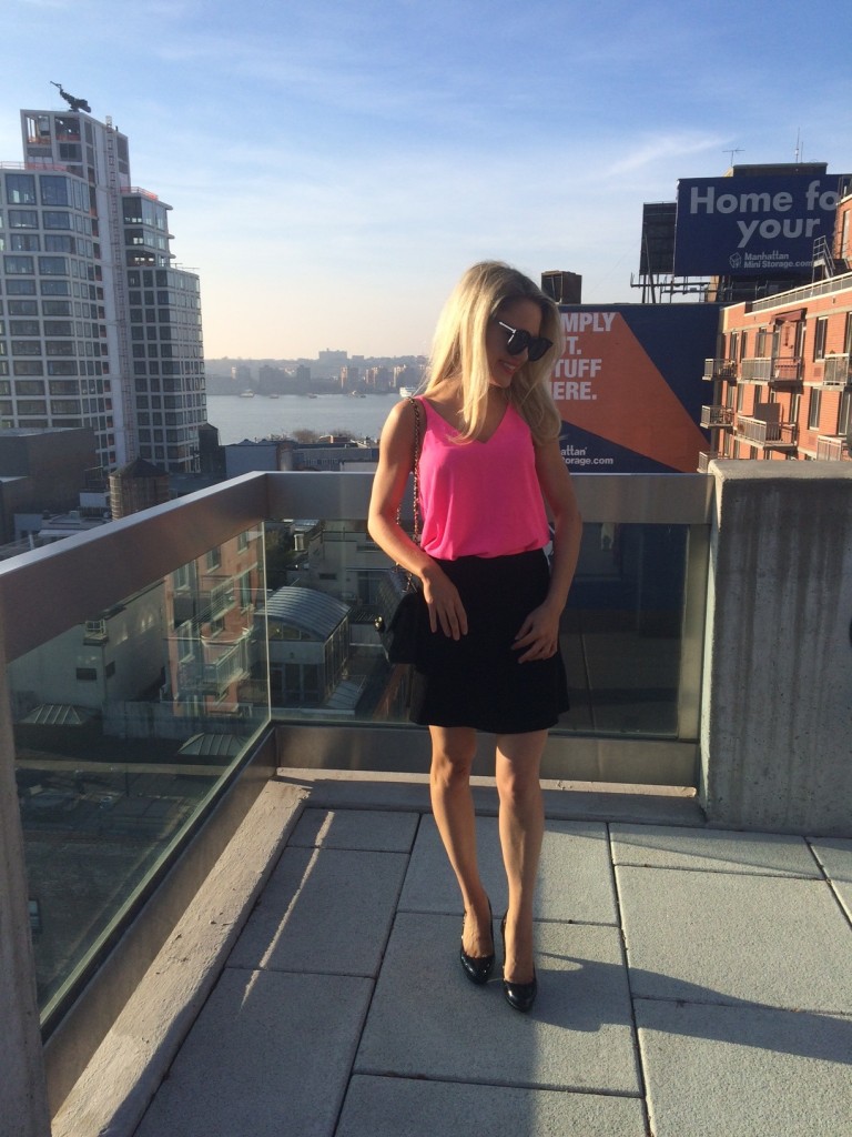 Caitlin Hartley of Styled American girl in bright pink tank top and karen walker sunglasses