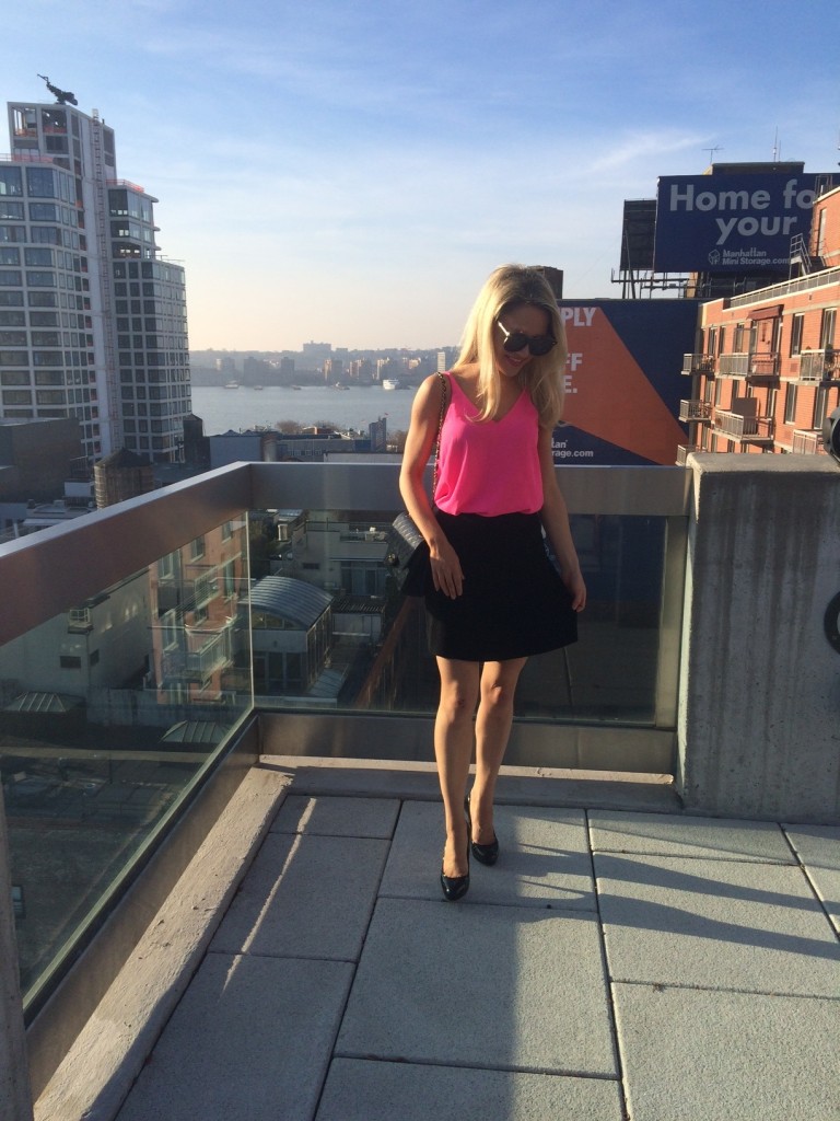 Caitlin Hartley of Styled American bright pink tank top, black chanel bag, mini skirt