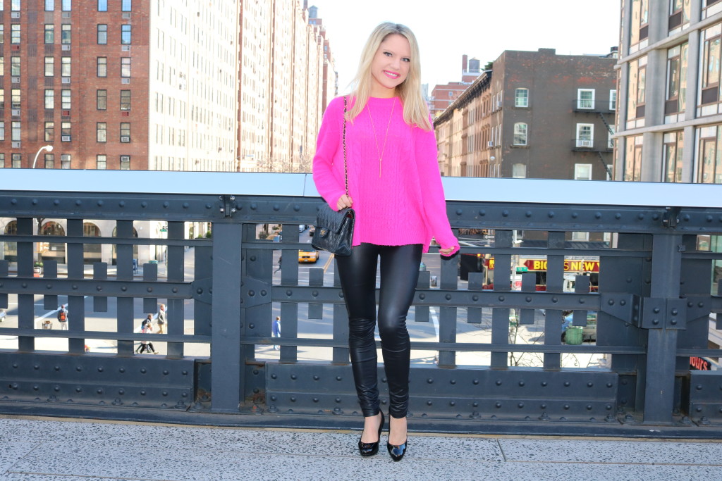 Caitlin Hartley of Styled American hot pink preppy sweater, gold pendent necklace, black leggings