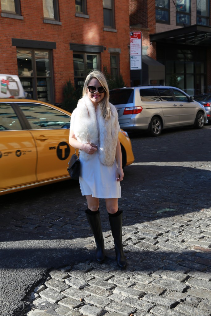 Caitlin Hartley of Styled American fux fur scarf, white dress and black sam edelman boots