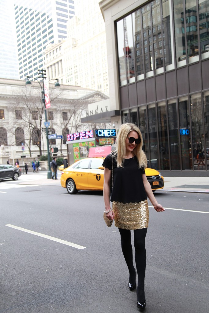 Caitlin Hartley of Styled American, black top, black tights, black pumps, seqin skirt and gold bag