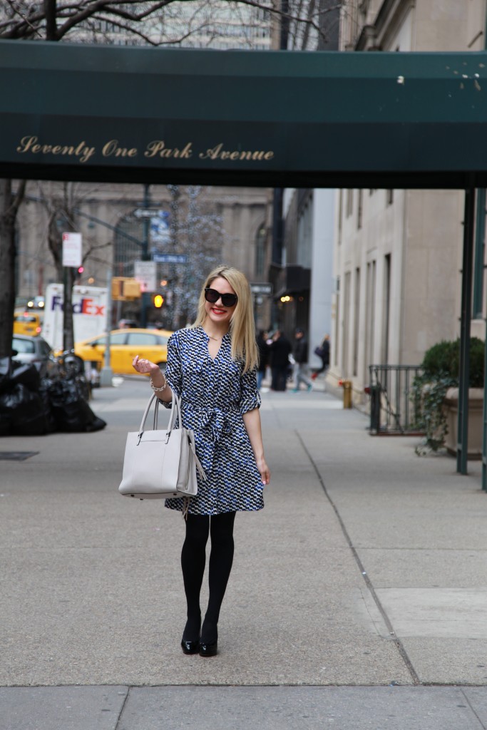 Caitlin Hartley of Styled American print work dress, grey tote and black pumps