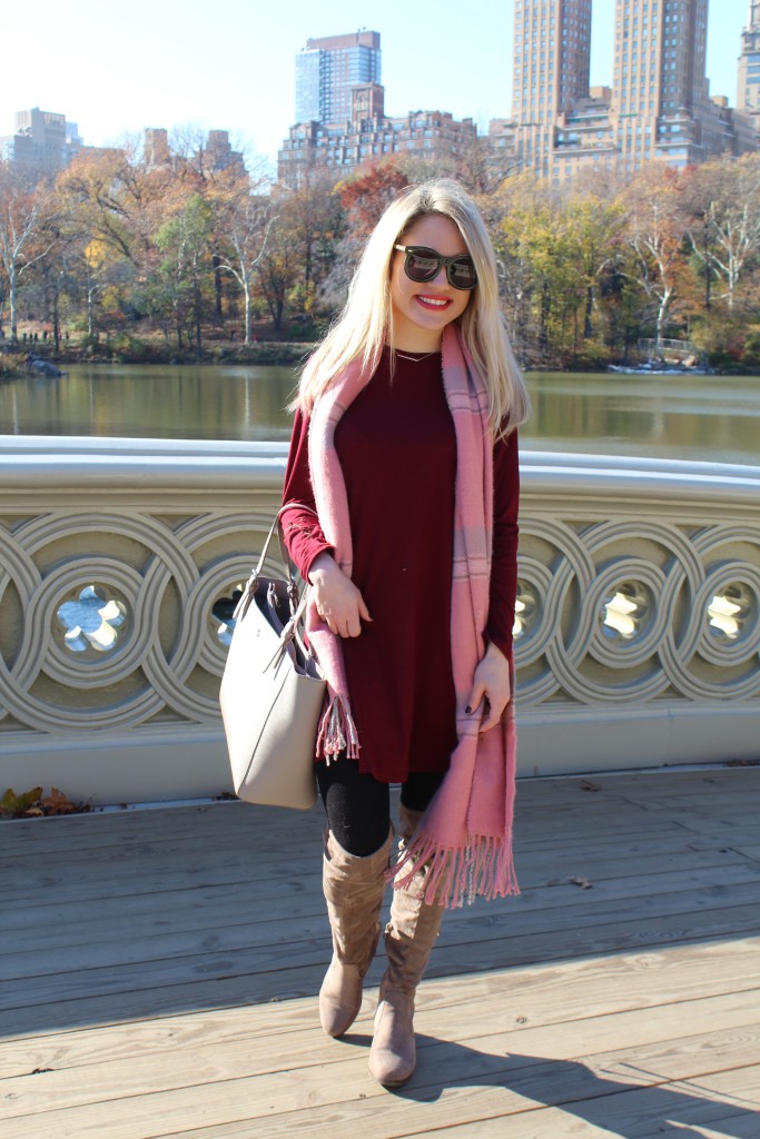 Caitlin Hartley of Styled American burgundy dress, suede boots, tote bag and oversized sunglasses