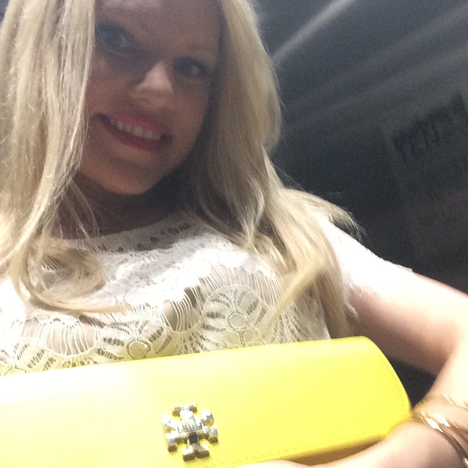 Caitlin Hartley of Styled American white lace top and yellow tory burch clutch, elevator selfie