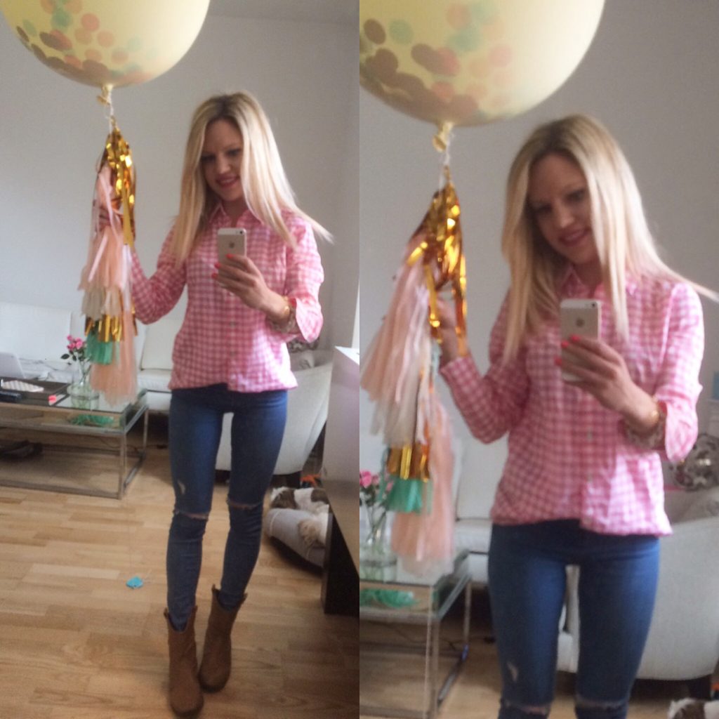 Caitlin Hartley of Styled American in a pink gingham top, skinny jeans, and holding a huge balloon with tassels