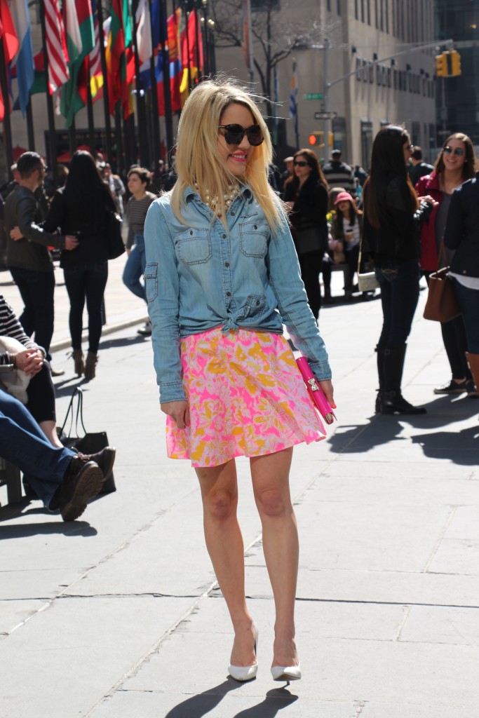 Caitlin Hartley of Styled American wearing a jean jacket with a floral skirt