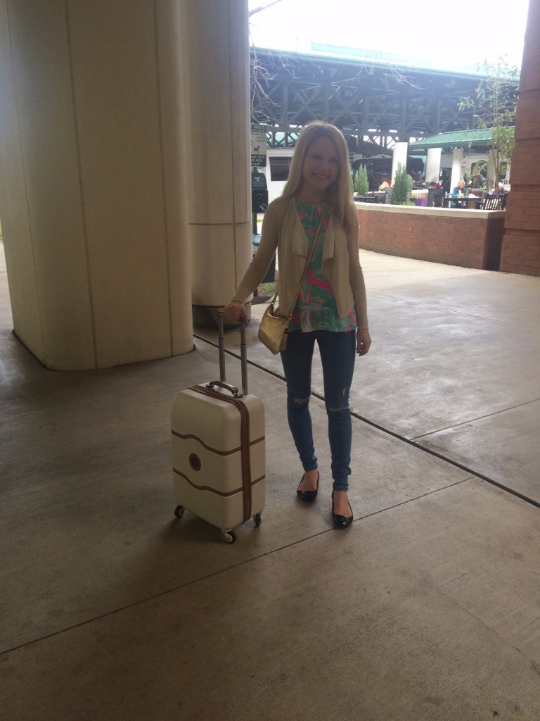 Caitlin Hartley of Styled American girl with white luggage, Delsey suitcase