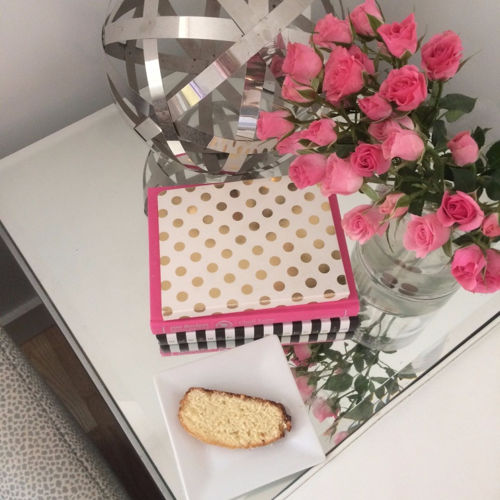 Caitlin Hartley of Styled American mini pink roses and kate spade books on mirrored coffee table