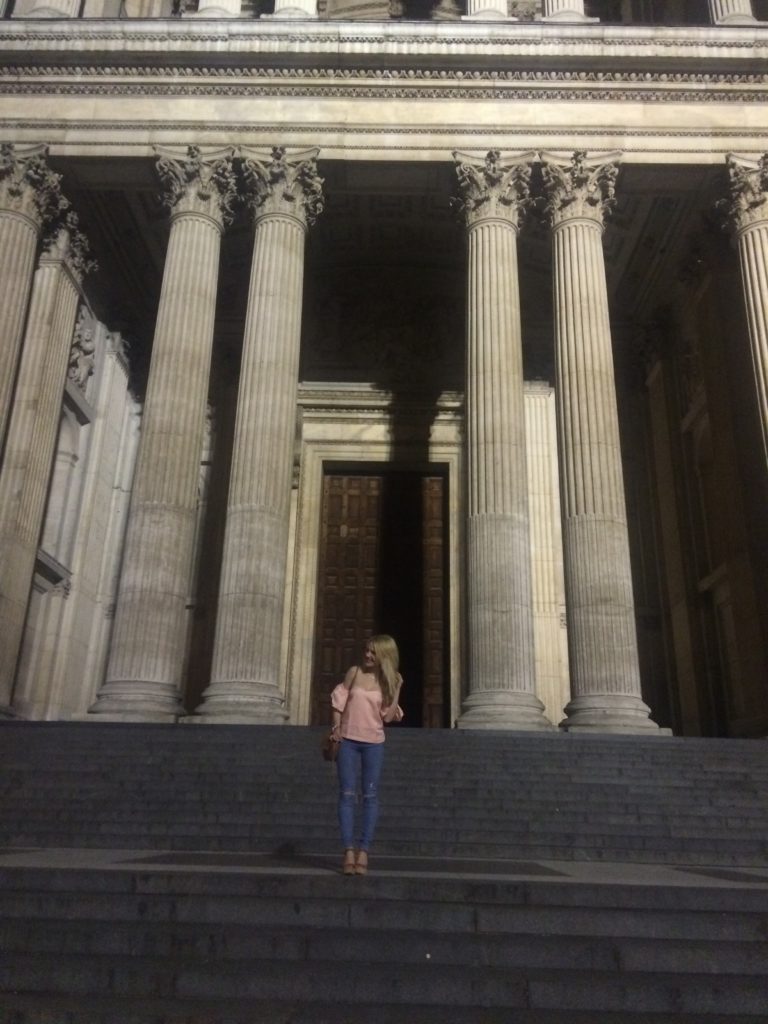 Caitlin-of-Styled-American-in-pink-top-and-jeans-on-st-paul's-cathedral-in-london