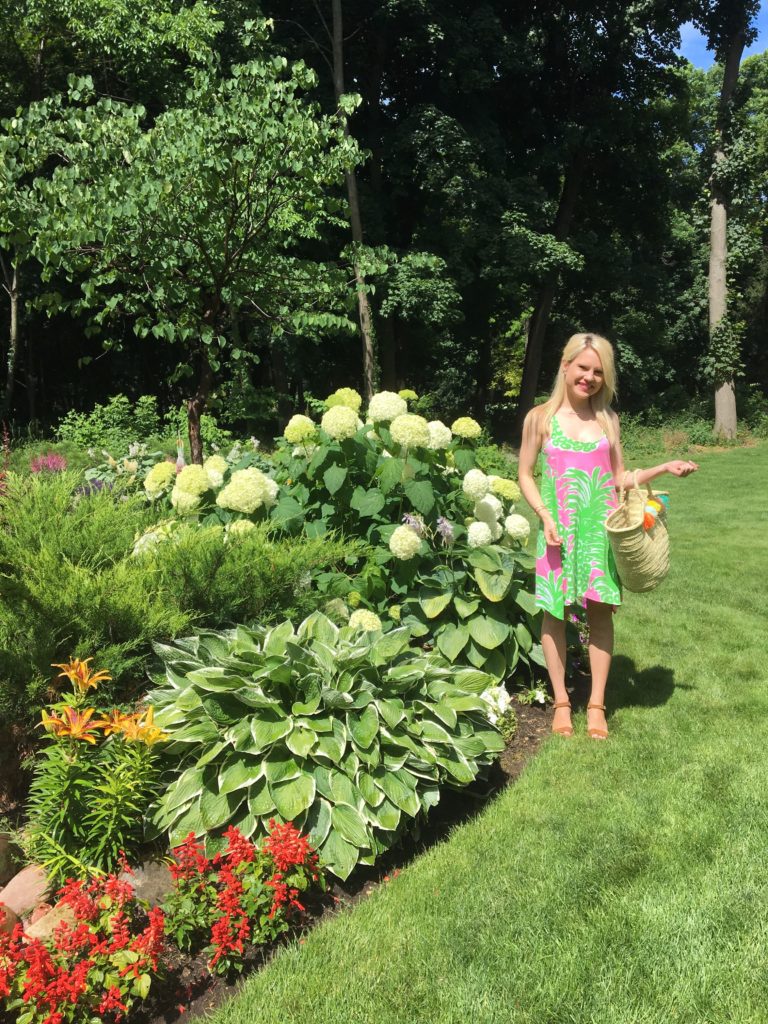 Caitlin-Hartley-of-Styled-American-in-front-of-hydrangeas-in-pink-green-lilly-pulitzer-dress