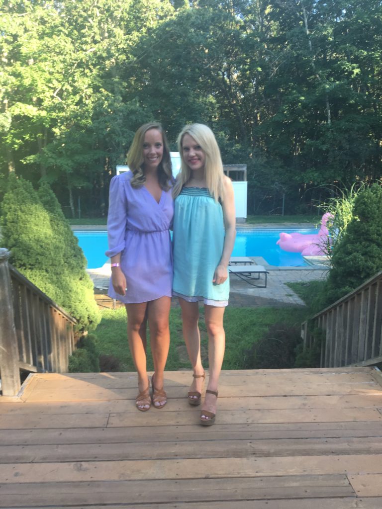 girls-in-blue-dress-purple-romper-in-front-of-pool