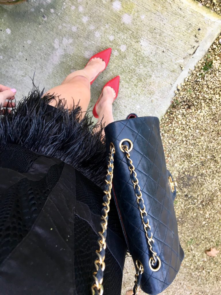 black-feather-dress-red-pumps-black-chanel-bag-from-above http://styledamerican.com/cocktail-dress-with-feather-hem/