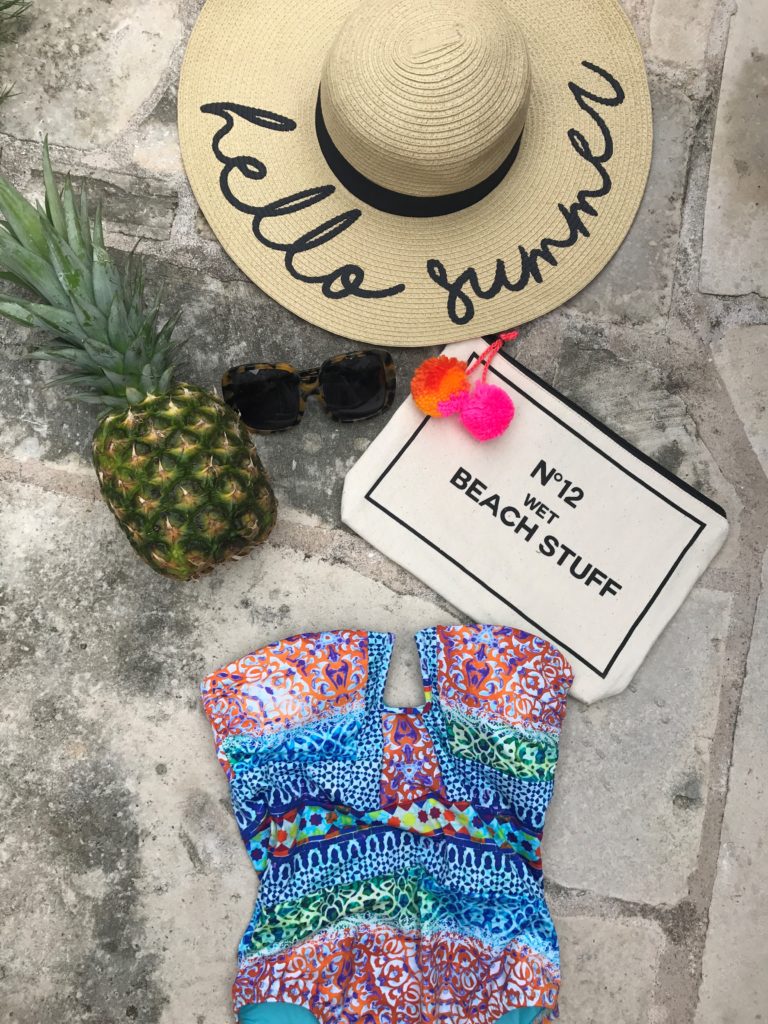 summer essentials, floppy hat, one piece suit, beach clutch